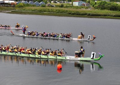Dragon boats racing to the finish at Race the River in the Campbell River estuary