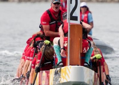 River Spirit crew paddling with the drummer at the front of the boat